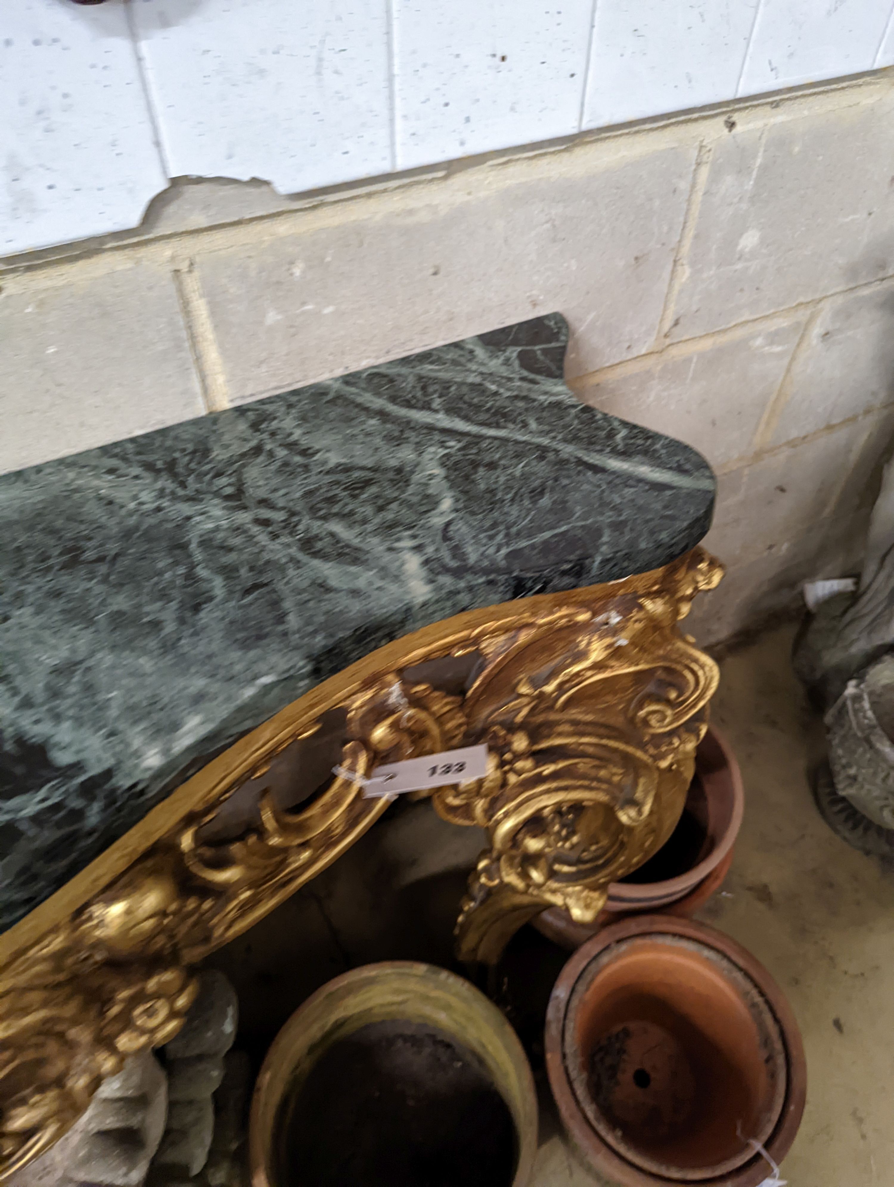 An 18th century style serpentine giltwood marble top console table, width 123cm, height 87cm